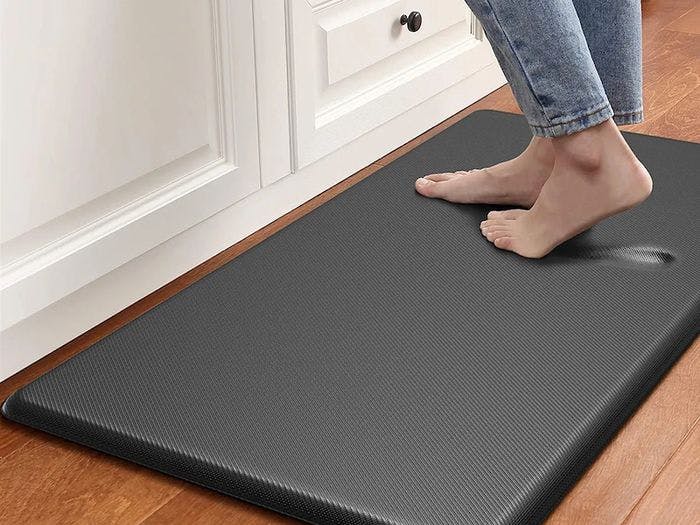 Buy two foam mats and place them near your stove and the sink.