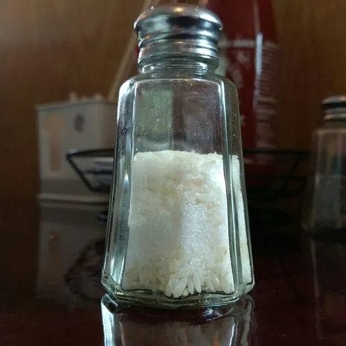 Put in a few grains of rice in a salt shaker to prevent the salt from clumping.