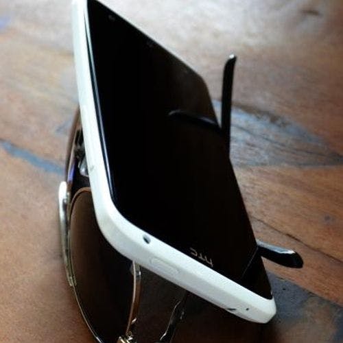 Create a phone stand out of your glasses or sunglasses.