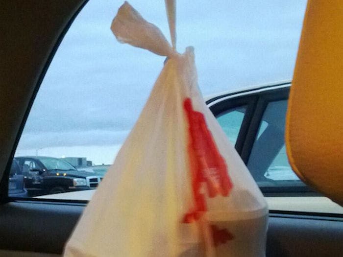 Hang your take-away food on the backseat handle's hook to prevent it from sliding around as you drive