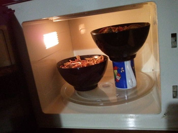 Use a mug to prop up your second bowl in the microwave