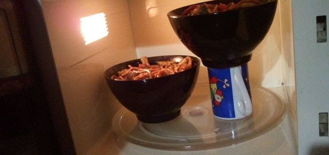 Use a mug to prop up your second bowl in the microwave